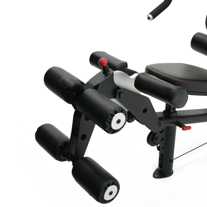 Inspire M2 multi gym leg developer attachment showing padded rollers for leg extension and curl exercises