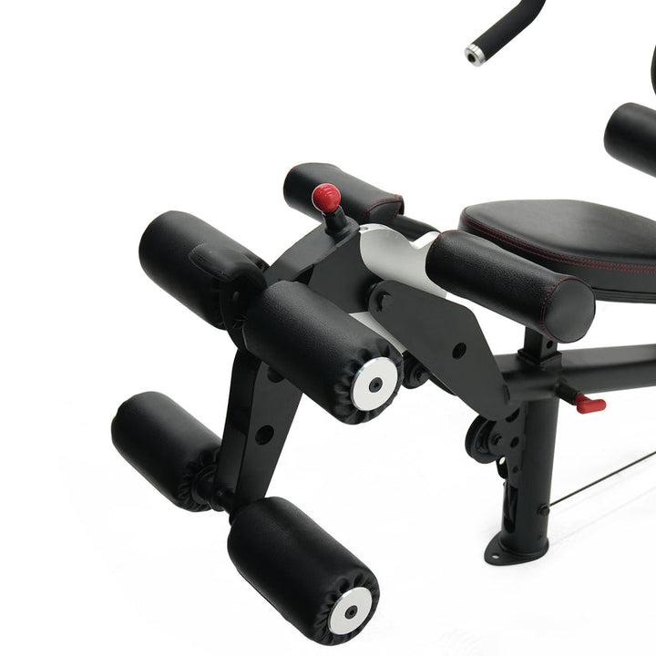 Inspire M2 multi gym leg developer attachment showing padded rollers for leg extension and curl exercises