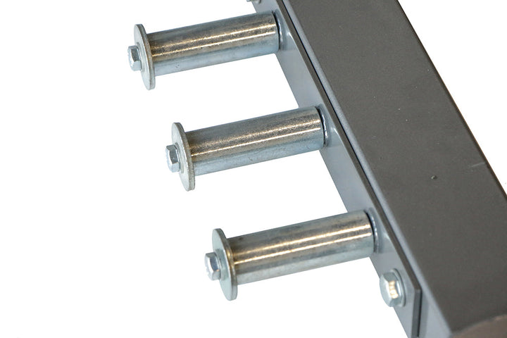 Integrated stainless steel weight plate storage horns on the Defiant Strength half rack.