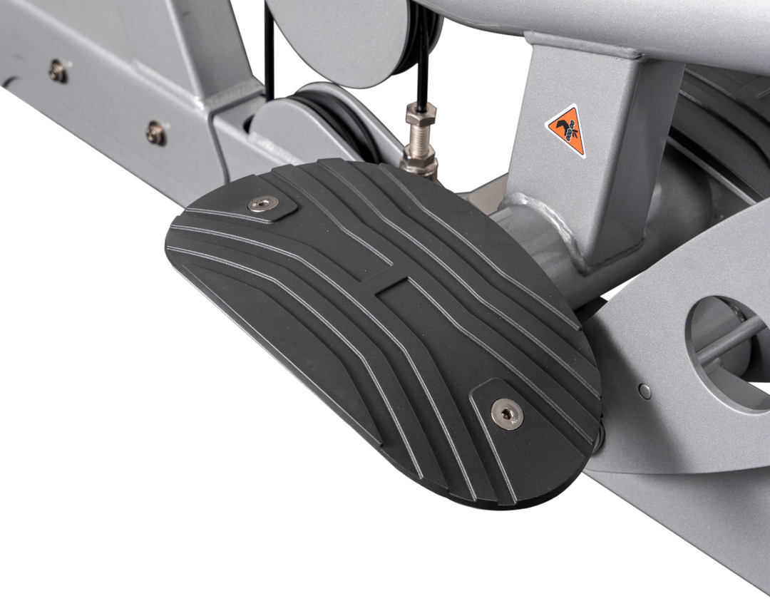 close-up of textured foot platform providing stability and support during lat pulldown exercise