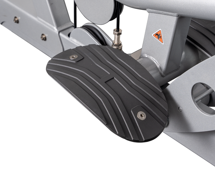 close-up of textured foot platform providing stability and support during lat pulldown exercise