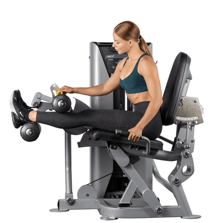 user demonstrating extended leg position on commercial leg press machine for quadriceps and glute training
