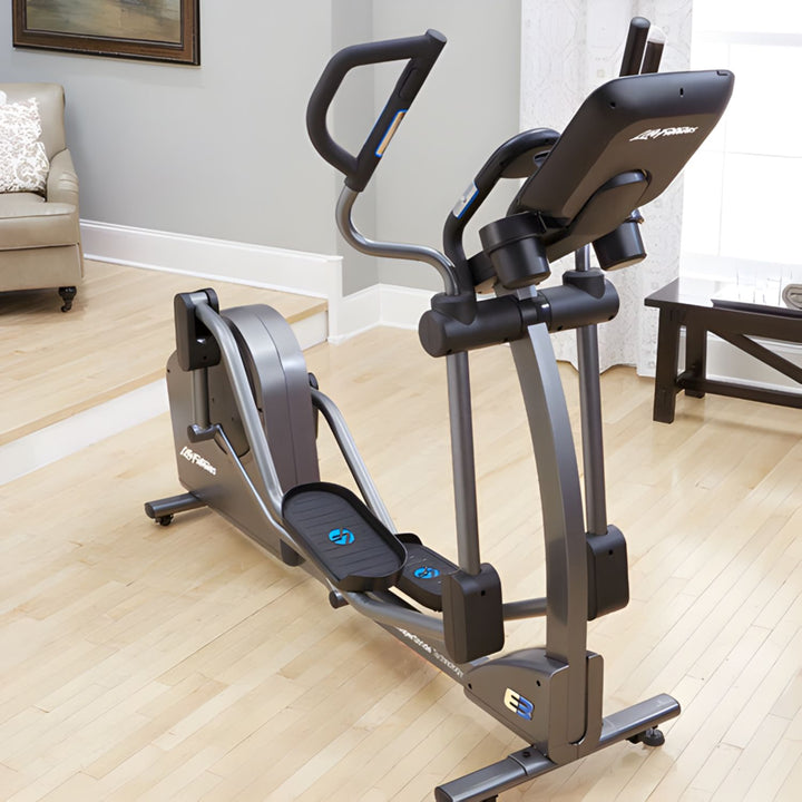 Life Fitness E3 elliptical cross trainer in home setting showing ergonomic handlebars smooth stride design and console for low impact cardio workouts