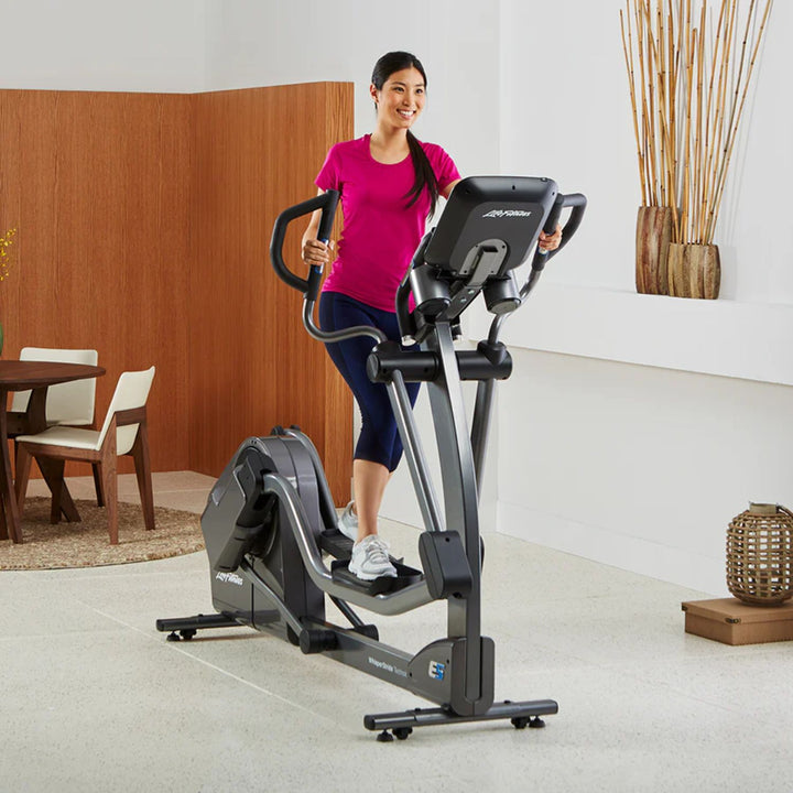 Life Fitness E5 elliptical cross trainer in home setting demonstrating adjustable stride motion and low impact full body cardio workout