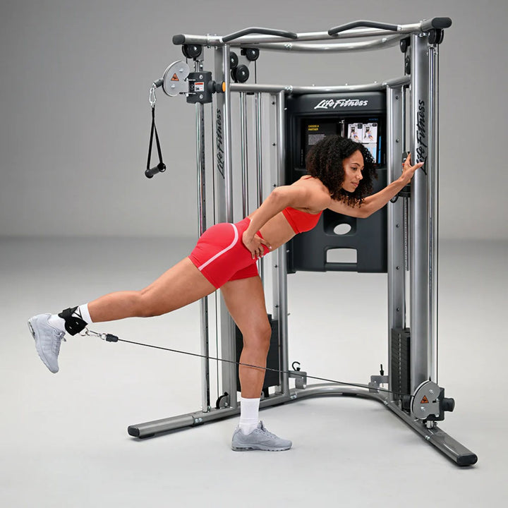 Life Fitness G7 home gym with user performing single-leg cable kickback for lower body strength training
