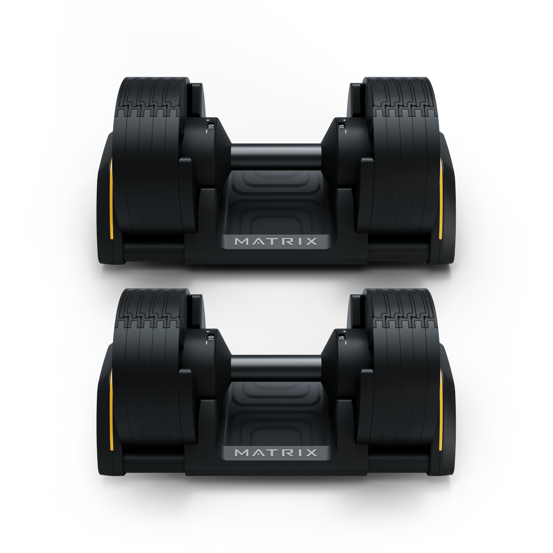 Front view of Matrix 50 lb dumbbells in cradle showing hex design and storage for strength training workouts
