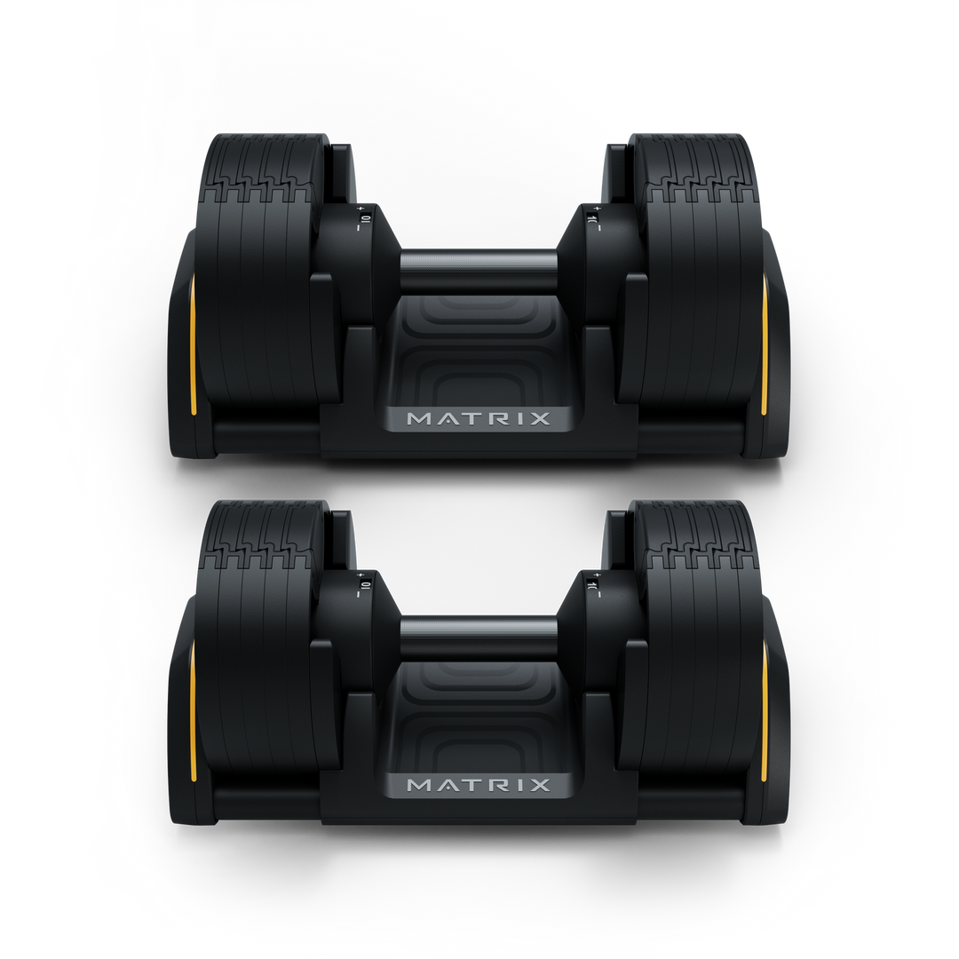 Front view of Matrix 50 lb dumbbells in cradle showing hex design and organized storage for strength training workouts