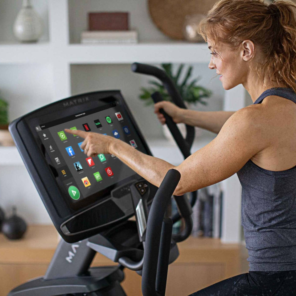 Matrix elliptical console options showing displays with workout metrics and touchscreen features