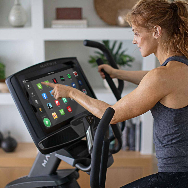 Matrix elliptical console options showing displays with workout metrics and touchscreen features