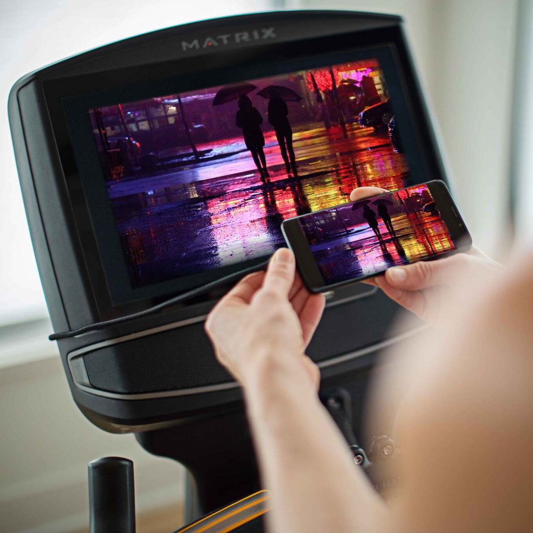 Matrix elliptical XIR console with touchscreen display showing workout programs, metrics, and interactive training features