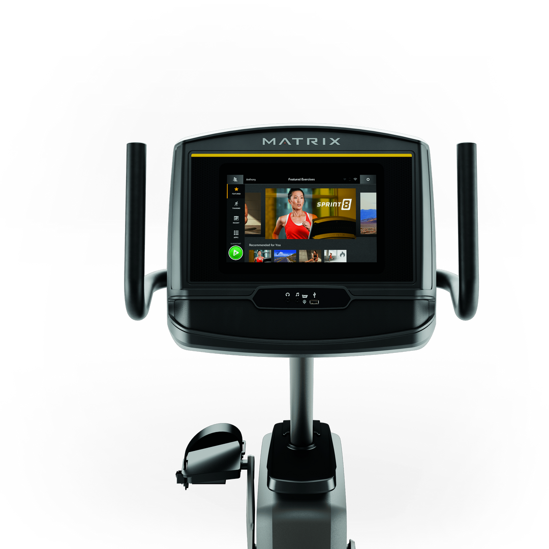 Front view of Matrix R30 recumbent bike with XER console showing workout metrics and ergonomic low impact design