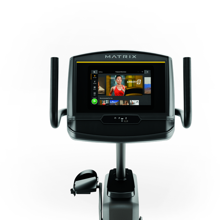 Front view of Matrix R30 recumbent bike with XER console showing workout metrics and ergonomic low impact design