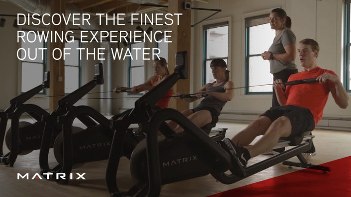 Person using the Matrix rowing machine during a gym workout.
