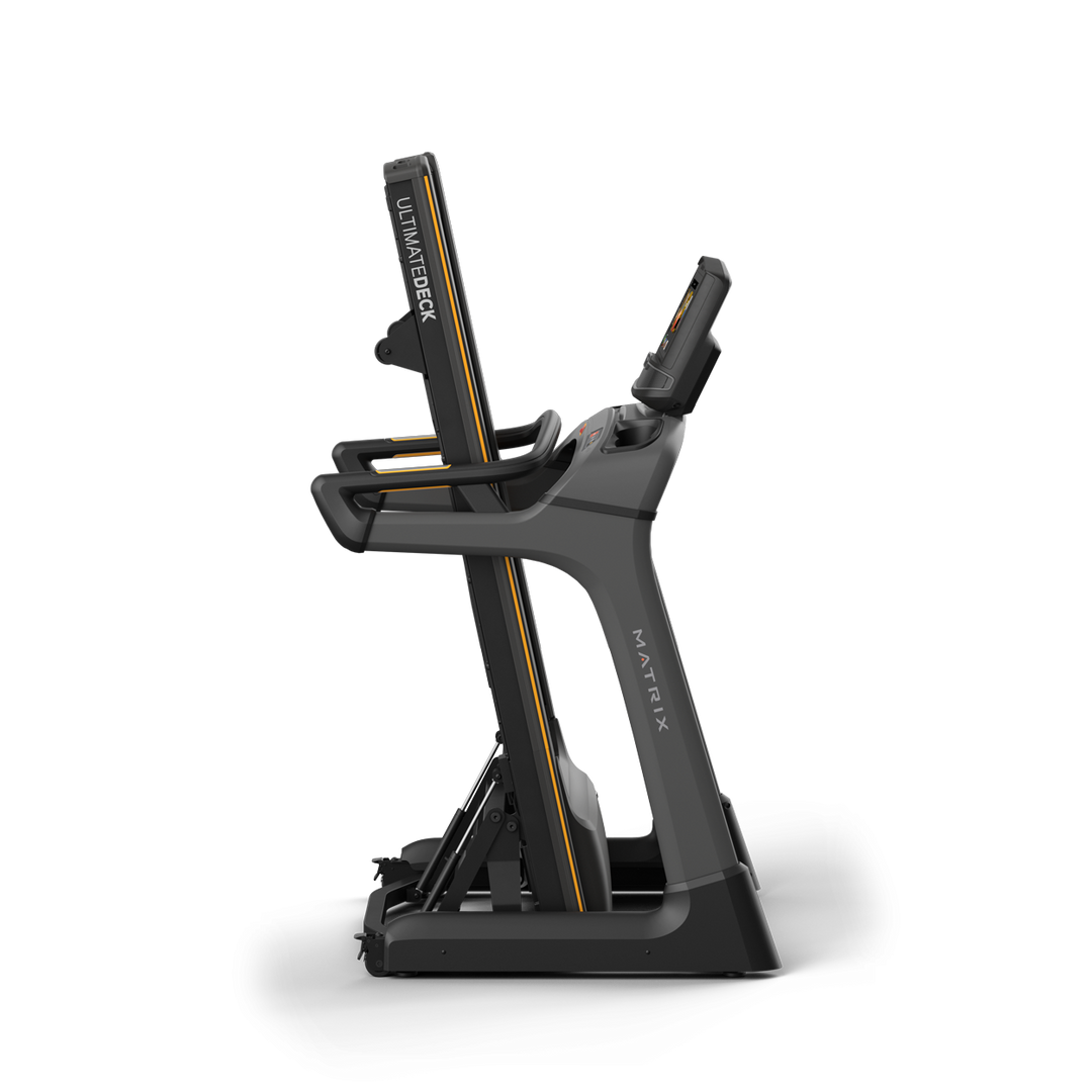 Side profile of Matrix TF30 folding treadmill in upright folded position with XIR touchscreen console and compact storage design