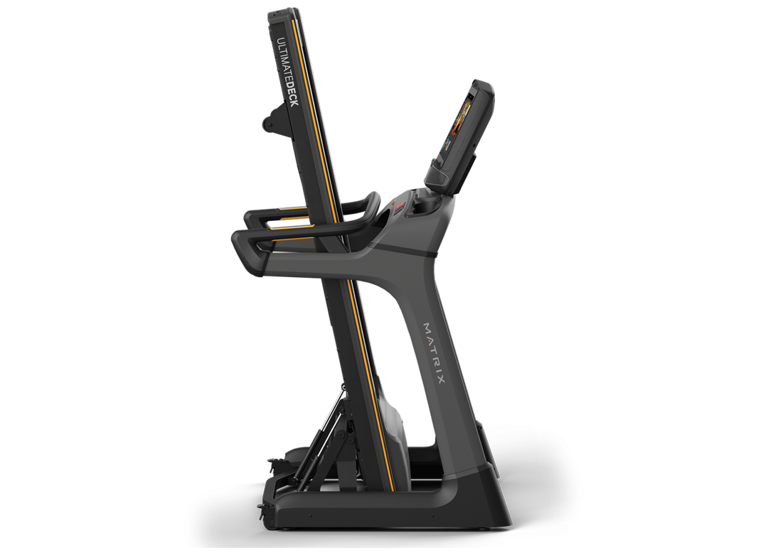Matrix TF50 folding treadmill in upright folded position with XUR console and space-saving design for home use