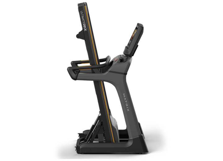 Matrix TF50 folding treadmill in upright folded position with XUR console and space-saving design for home use