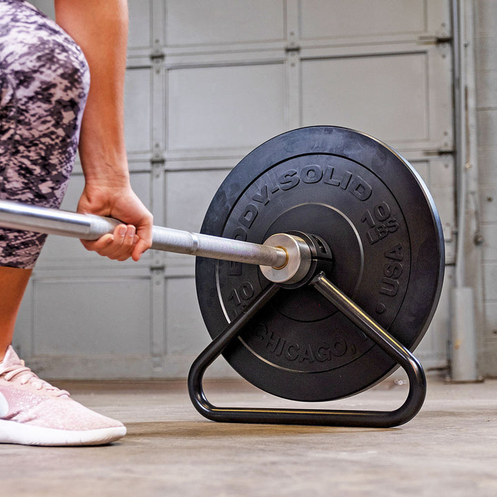 Olympic bar stand raising a loaded barbell for easier weight plate changes.