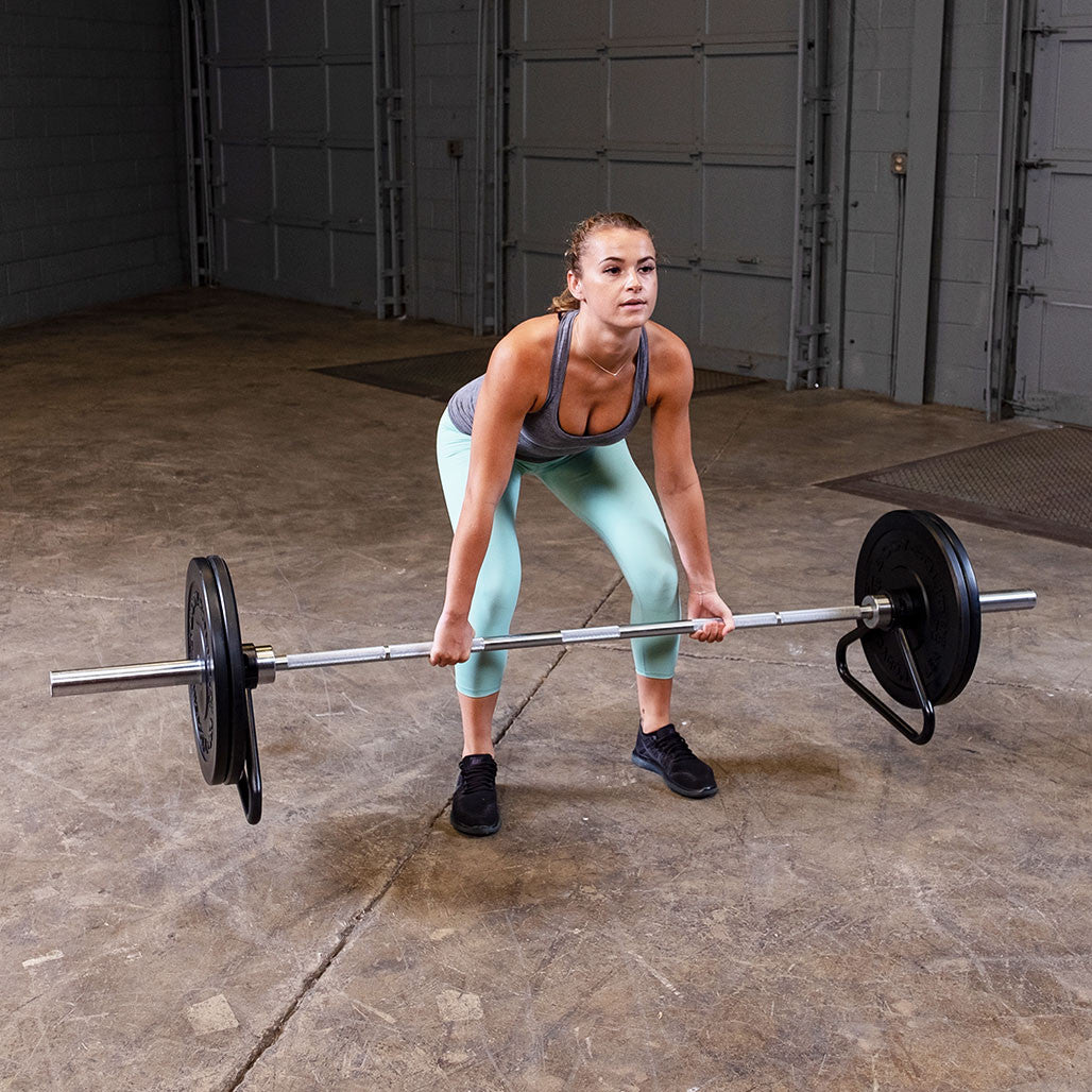 Athlete preparing for a deadlift using an Olympic bar stand.