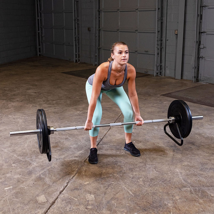 Athlete preparing for a deadlift using an Olympic bar stand.