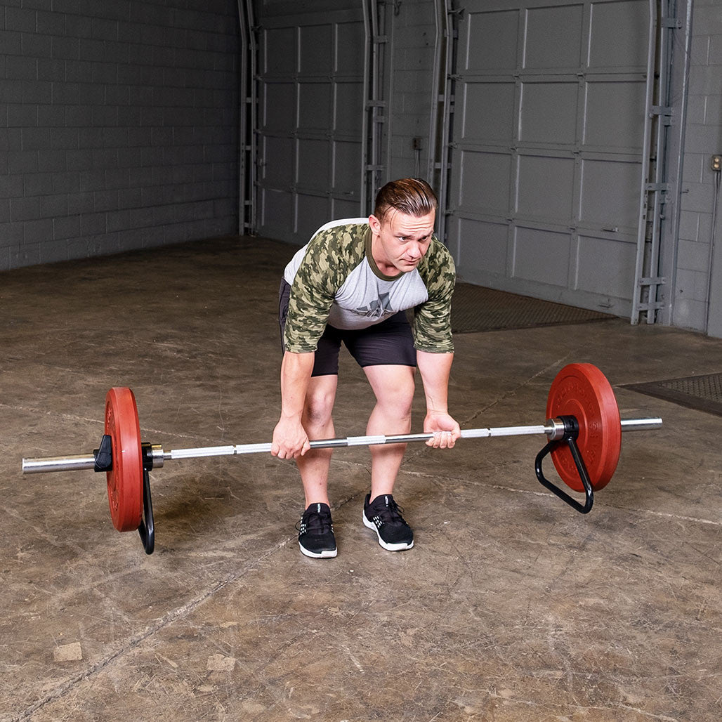 Person performing a deadlift with an Olympic bar equipped with a bar stand.