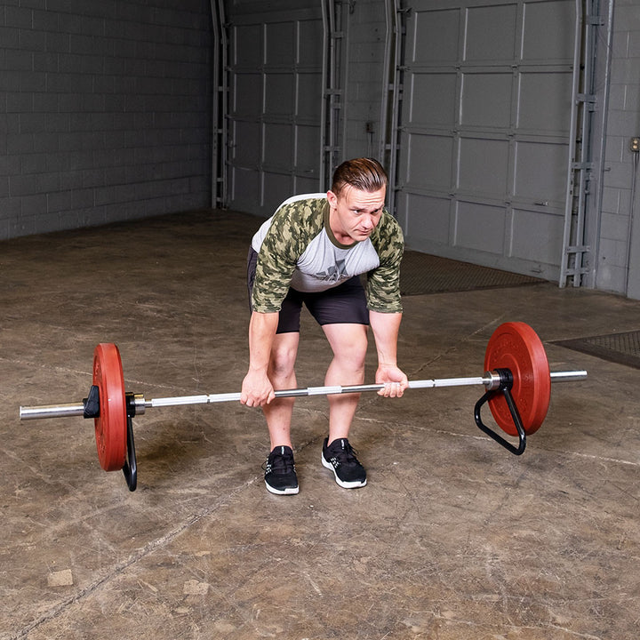 Person performing a deadlift with an Olympic bar equipped with a bar stand.