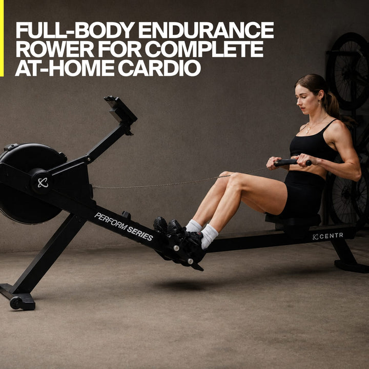 Person using the Centr Perform Series rowing machine during a home cardio workout.