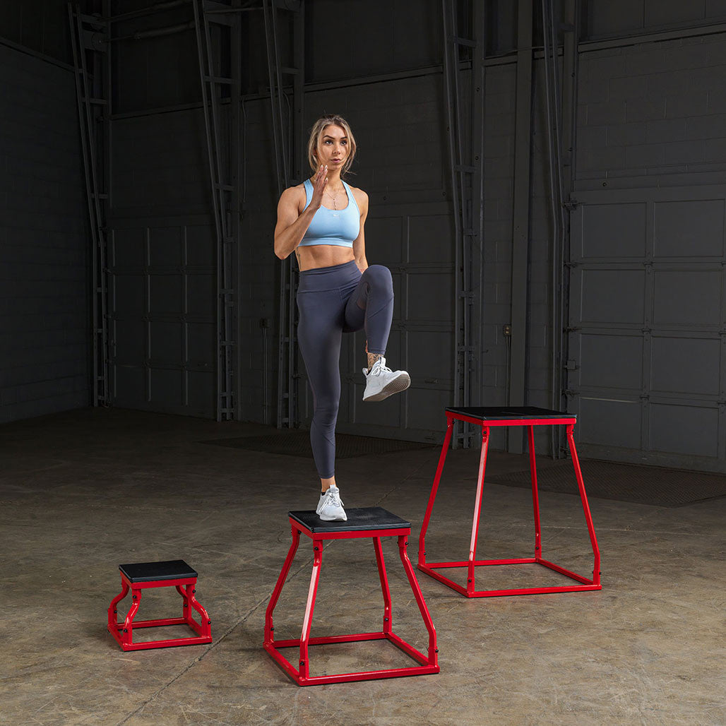 Athlete performing step-up exercises with steel frame plyo boxes.