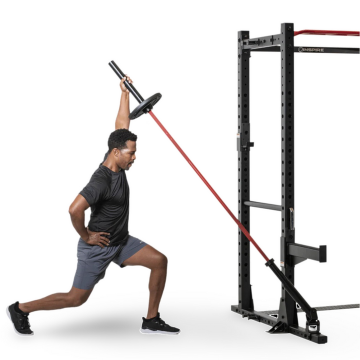 athlete performing resistance band exercise attached to power cage for strength and conditioning training
