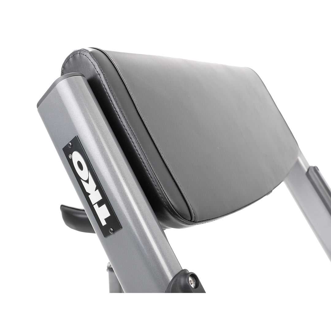 Close-up of padded arm support on preacher curl bench