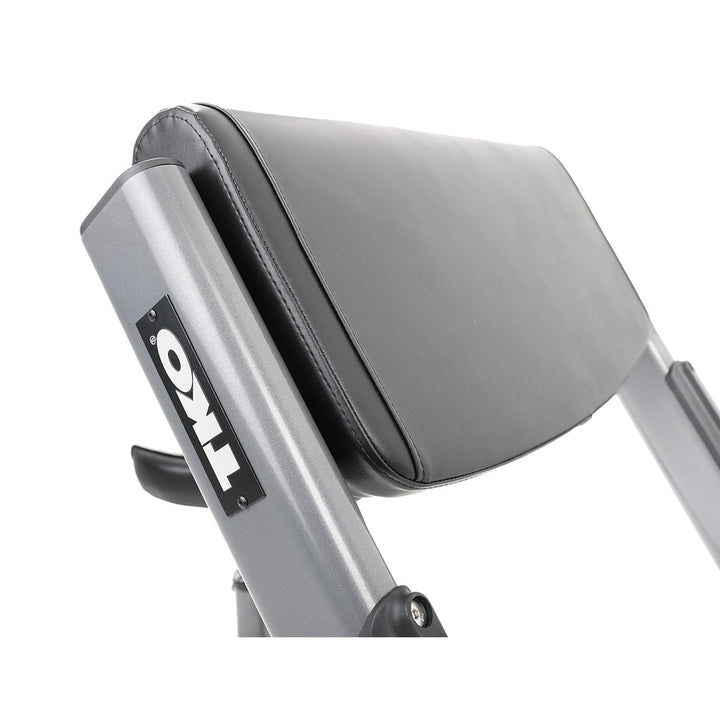 Close-up of padded arm support on preacher curl bench