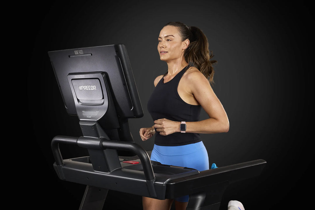 Runner using the Precor Breakaway commercial treadmill during a cardio workout.
