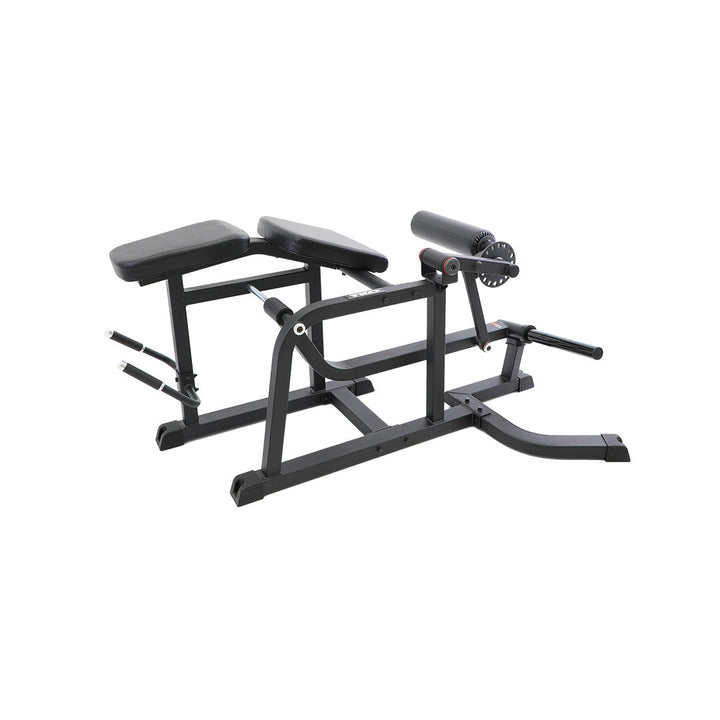 Side view of prone leg curl machine showing bench and leg roller assembly.