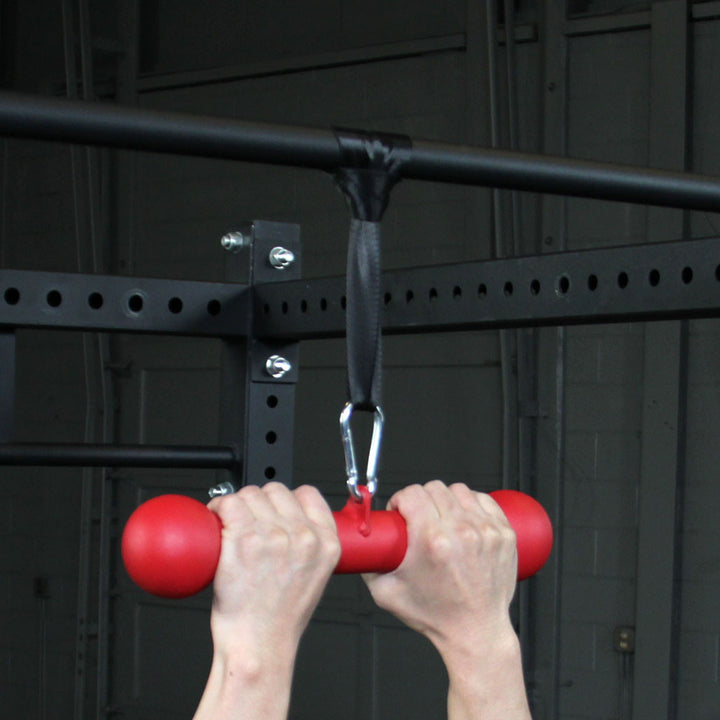 Athlete performing pull-ups using the Body-Solid BSTDB dog bone grip trainer.