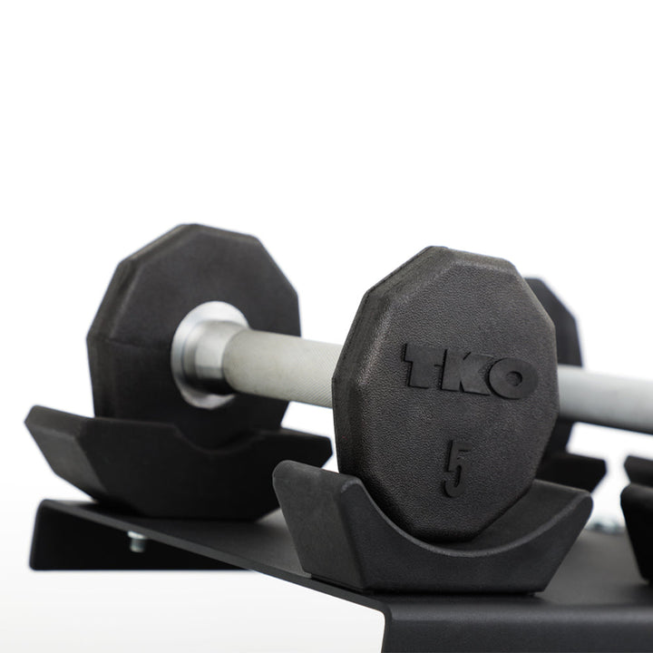 Round head dumbbell resting in nylon-protected saddle