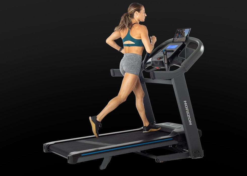 Person running on the Horizon 7.4 AT treadmill during a workout.