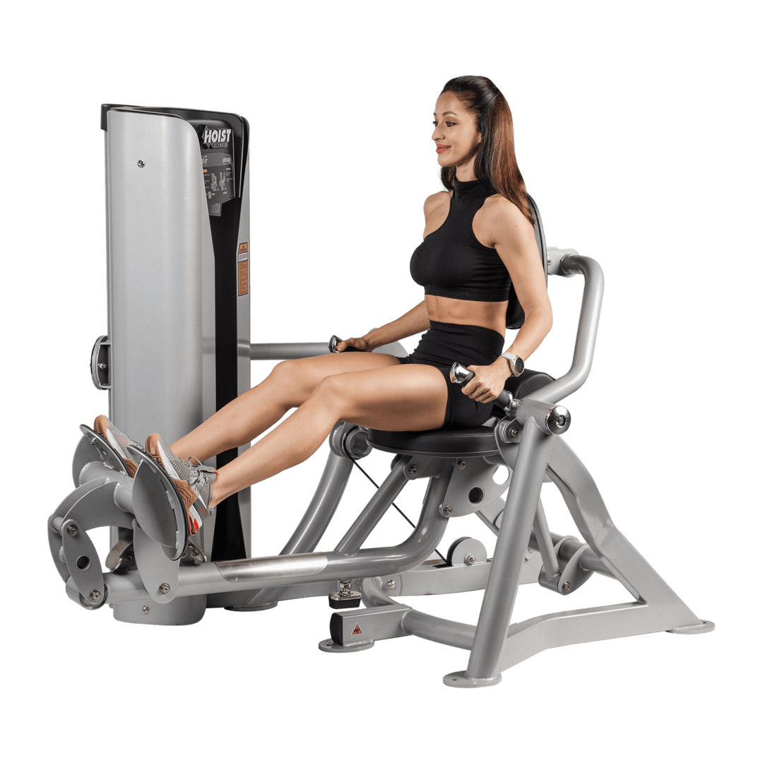 woman pulling handles toward torso on seated mid row machine demonstrating proper back contraction and rowing form