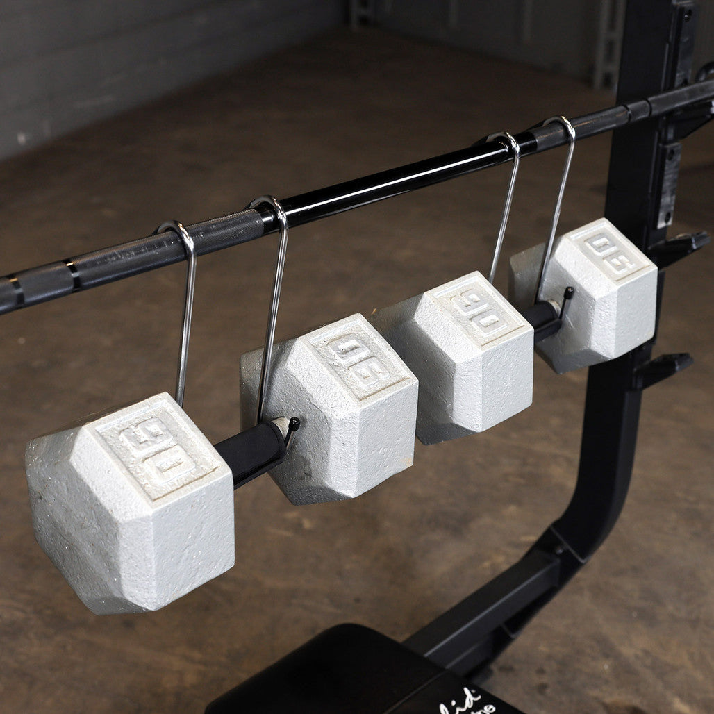 Body-Solid dumbbell spotter hooks suspending dumbbells from a barbell.