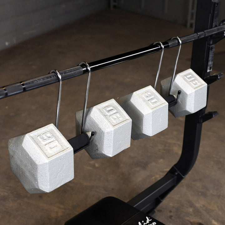 Body-Solid dumbbell spotter hooks suspending dumbbells from a barbell.