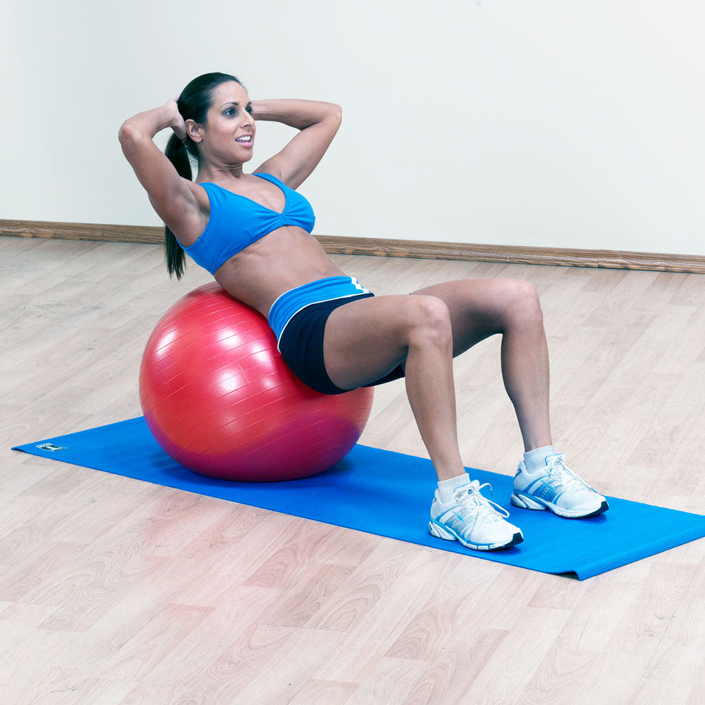 Woman performing a supported core exercise on a red Body-Solid stability ball