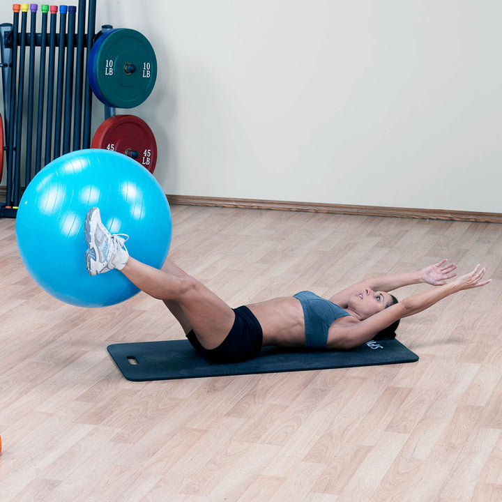 Woman performing a floor core exercise with a blue Body-Solid stability ball