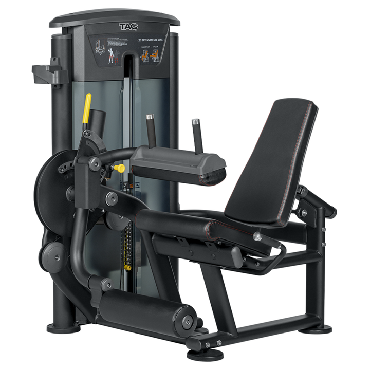TAG Fitness ELITE leg extension/curl machine in black with padded seat, backrest, leg rollers, handles, and weight stack