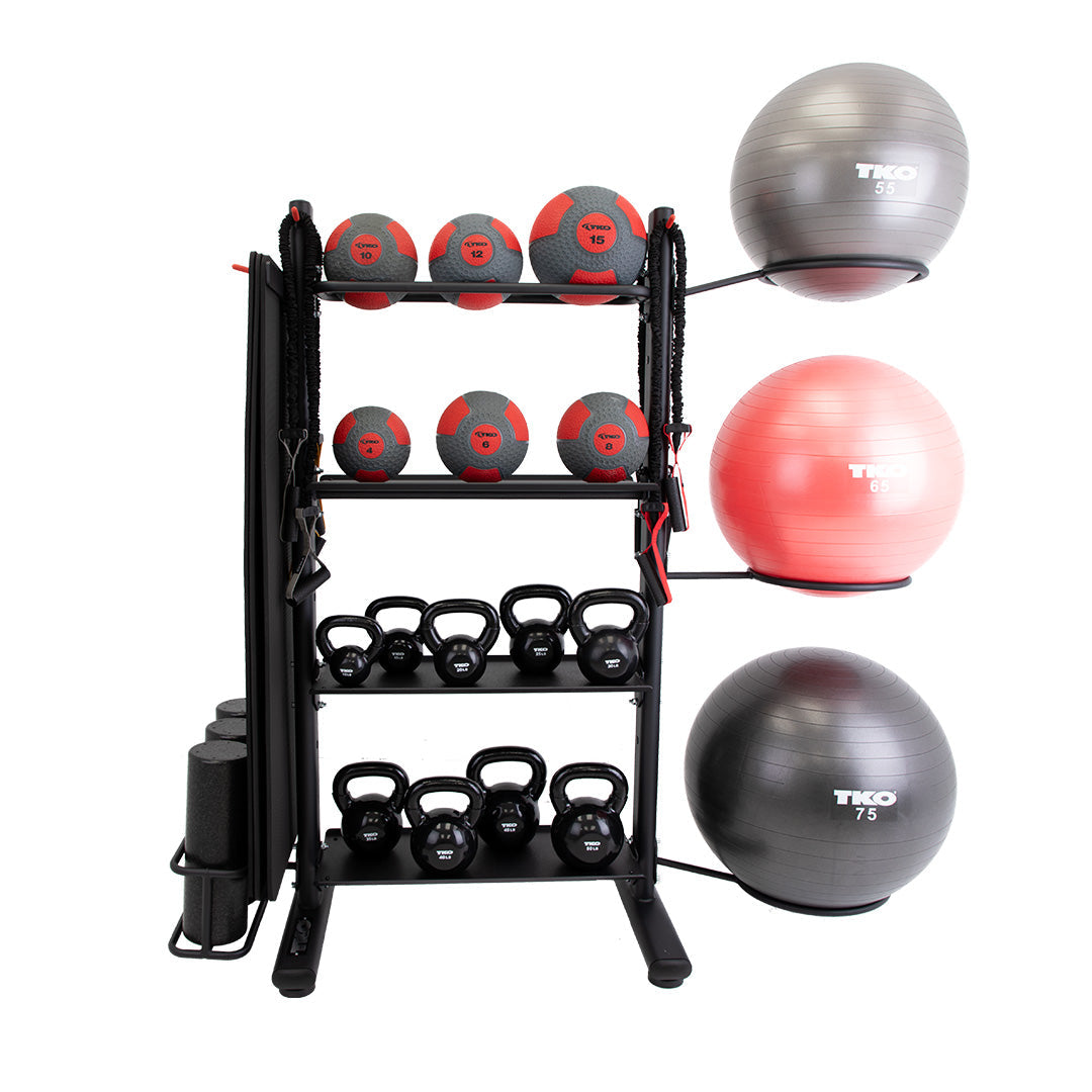 TKO accessory storage rack with medicine balls, kettlebells, mats, foam rollers, and stability balls