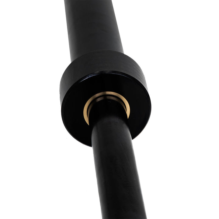 Close-up of sleeve and brass bushing assembly on Olympic camber bar