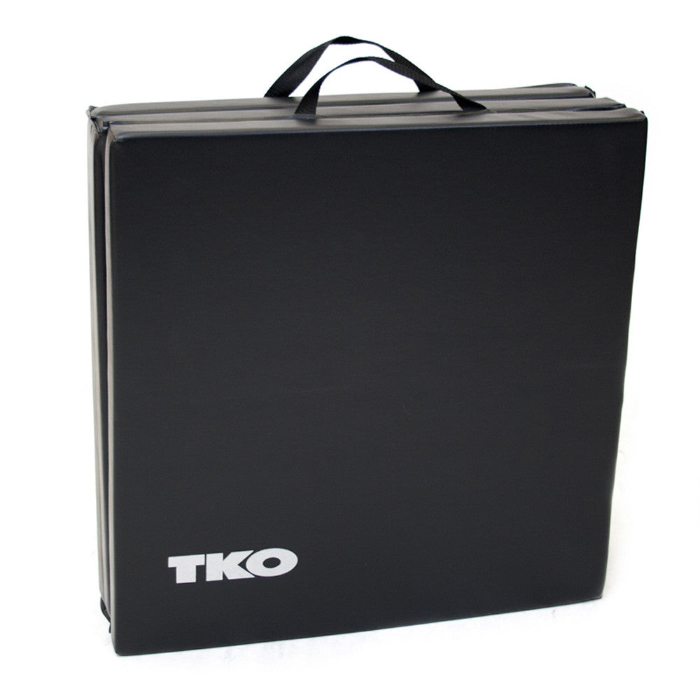 Folded TKO exercise mat with carrying handles for easy storage and transport