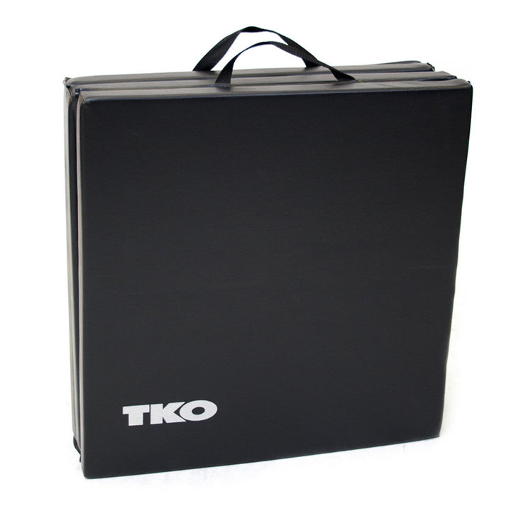Folded TKO exercise mat with carrying handles for easy storage and transport