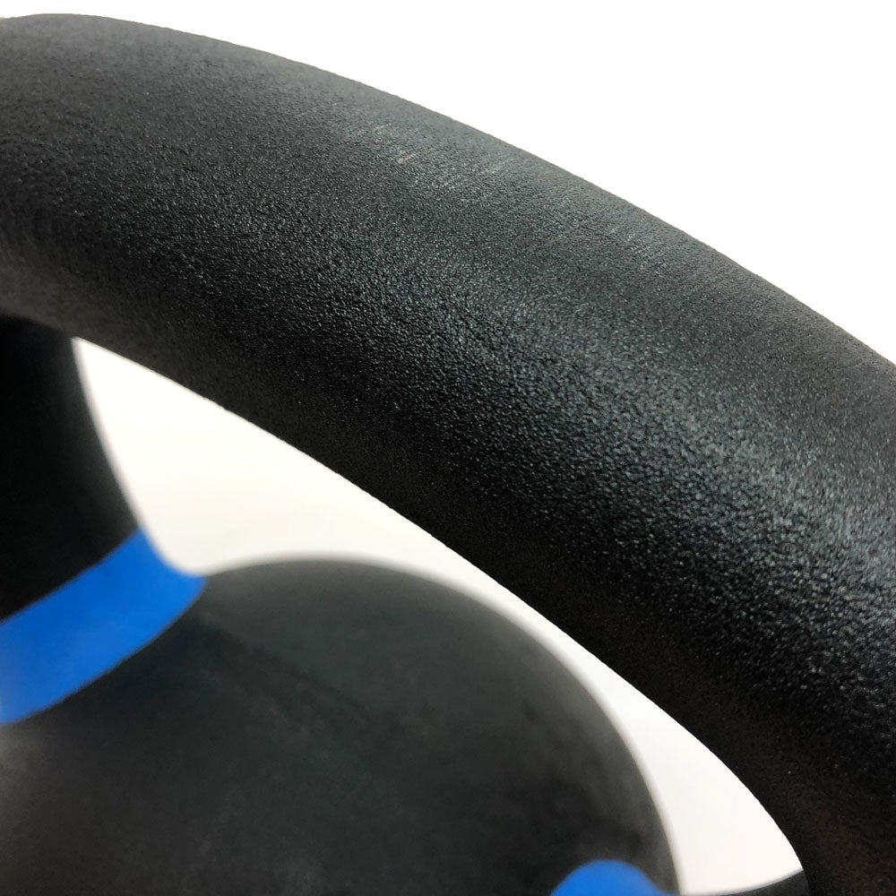 Close-up of textured kettlebell handle with color-coded band