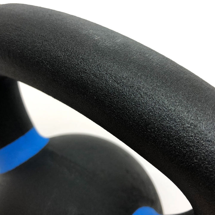 Close-up of textured kettlebell handle with color-coded band