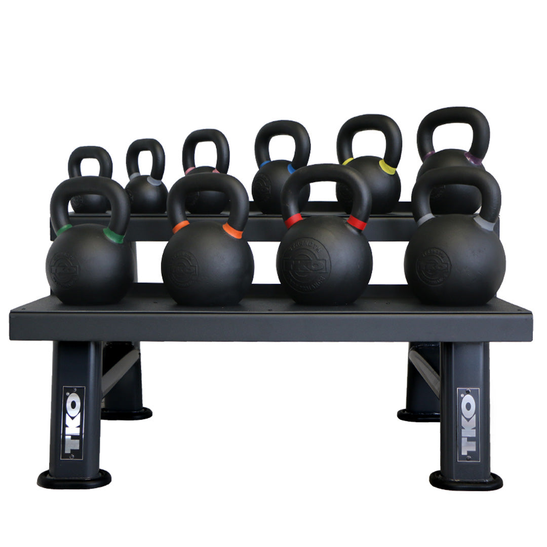 Multiple TKO Pro Cast kettlebells organized on storage rack
