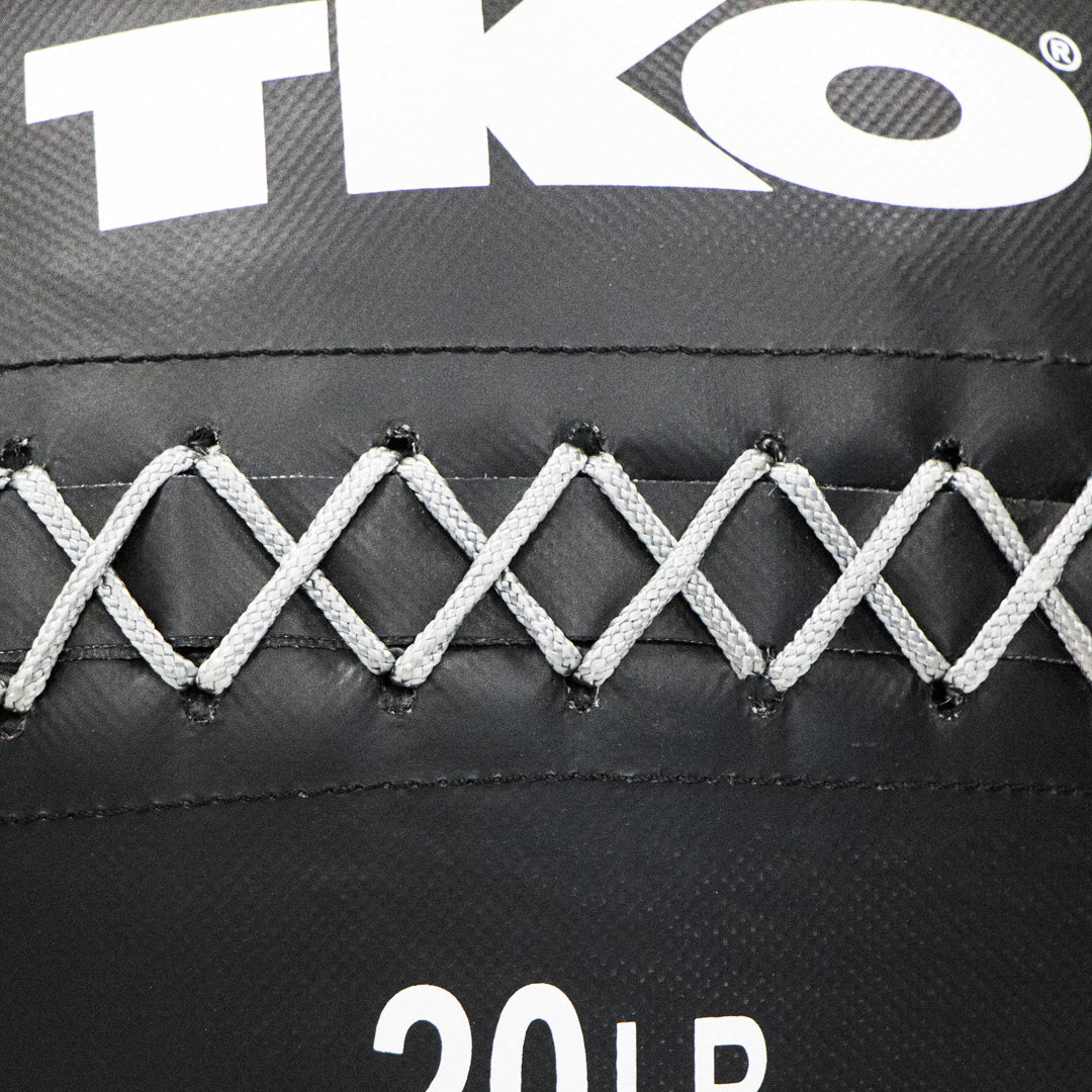 Close-up of reinforced gray lacing and stitching on TKO wall ball