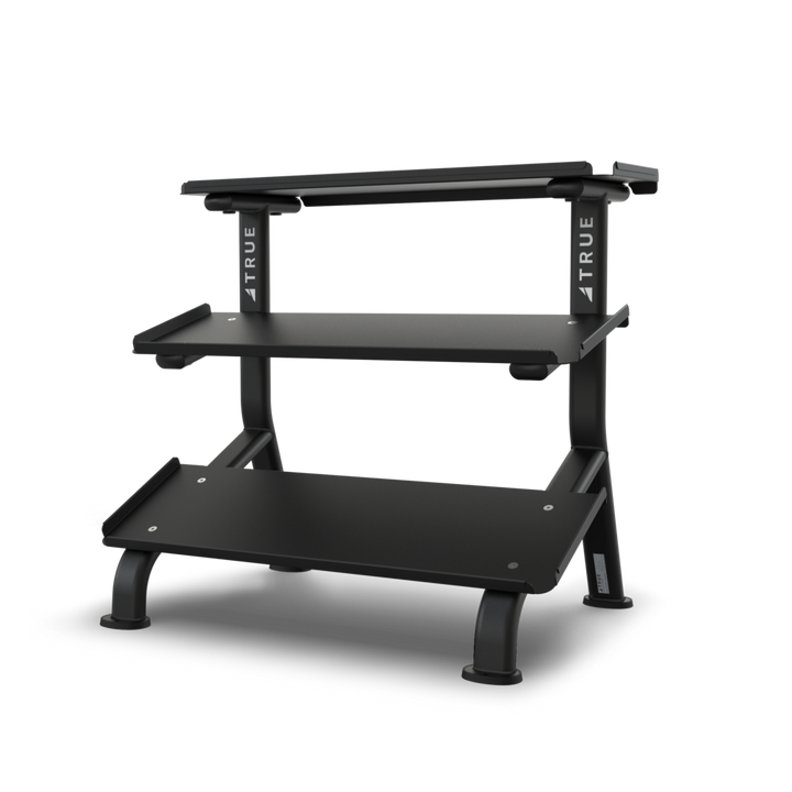 TRUE FS-24 3-tier flat tray dumbbell rack shown empty from the front with three storage trays